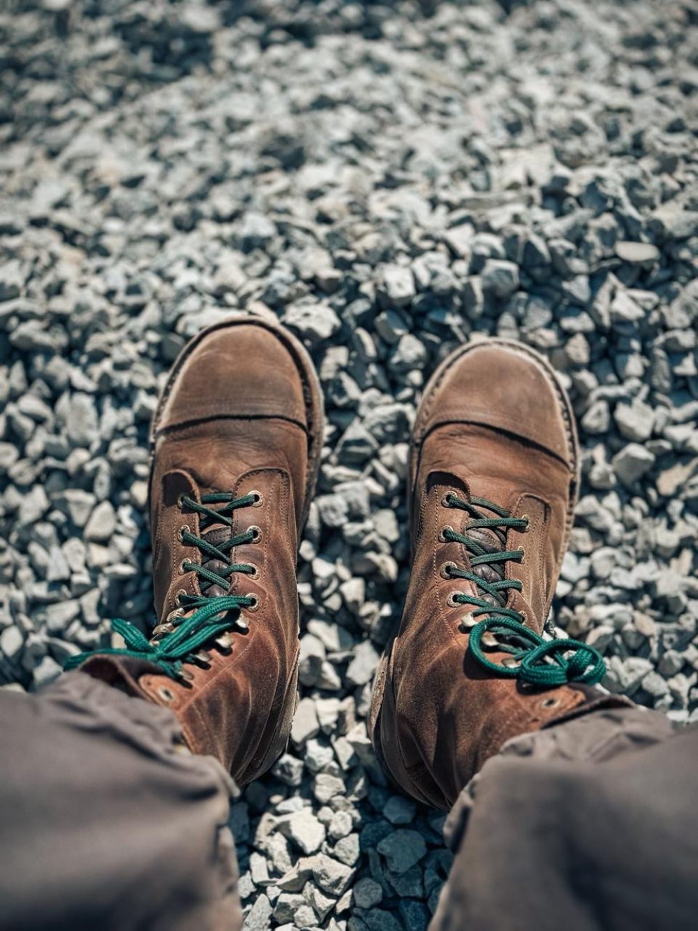 Adventure guide boots dusted from dirt roads and river crossings